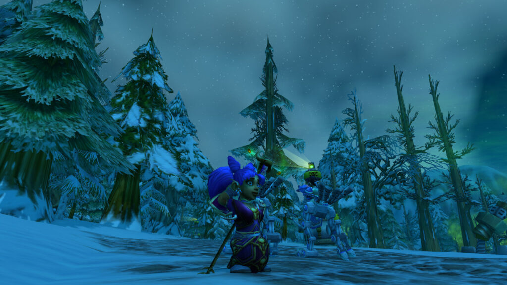 A snowy pine forest at night